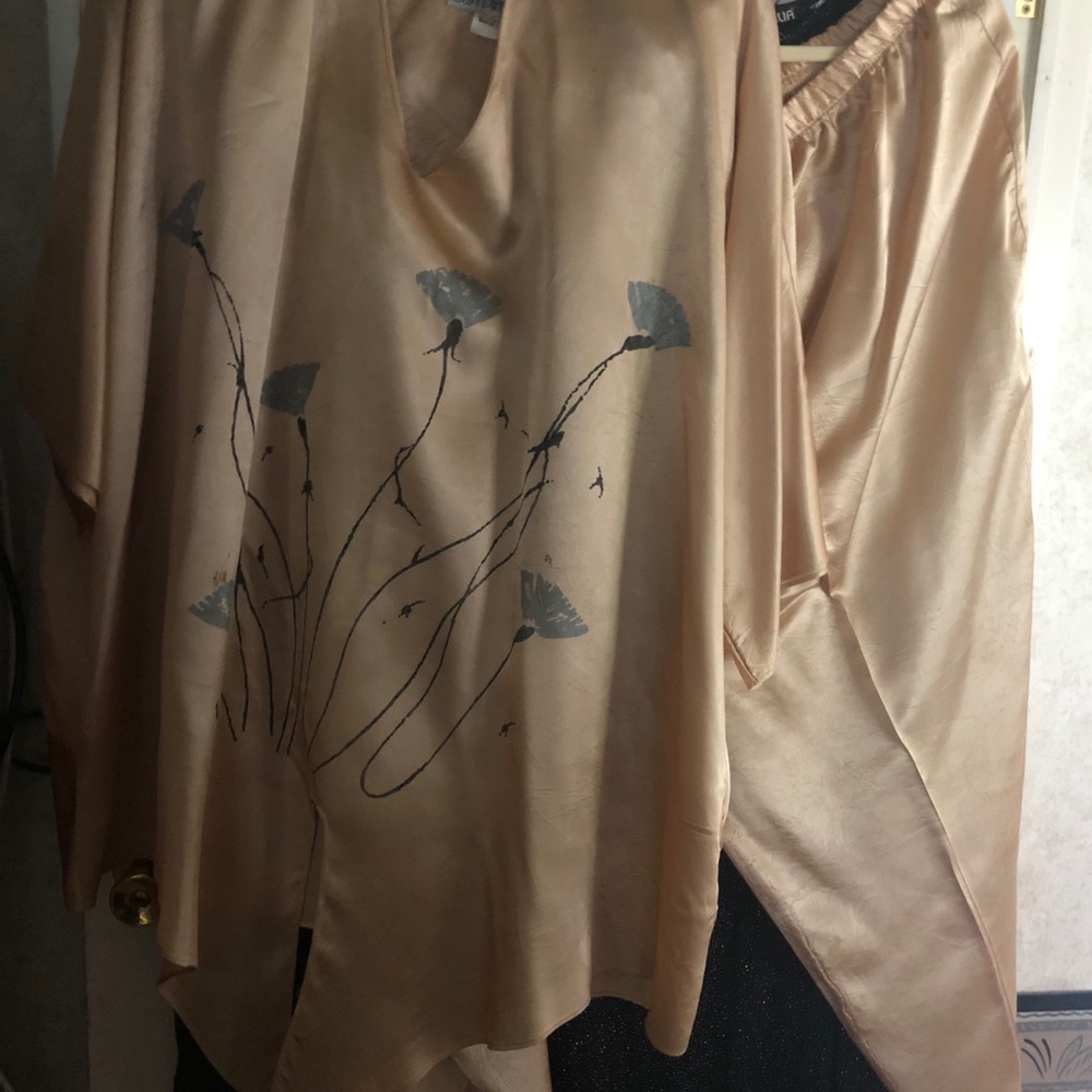 A beautiful gold, silver and black pants suit.